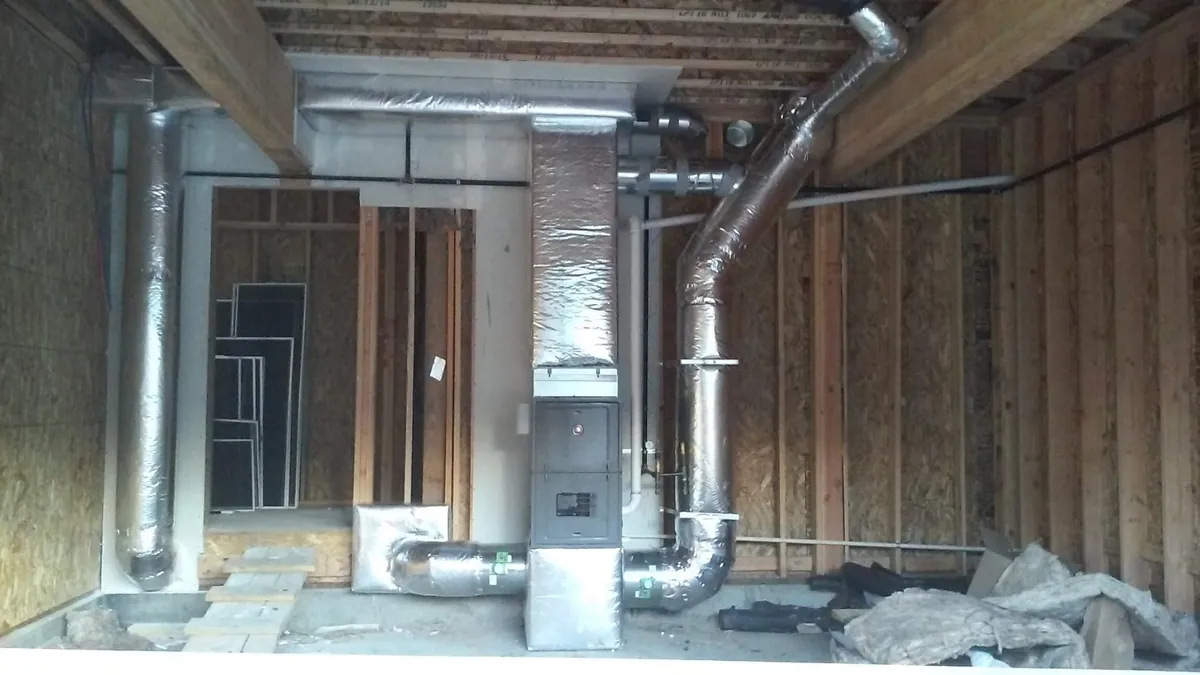 New-construction furnace and insulated ductwork in unfinished framing