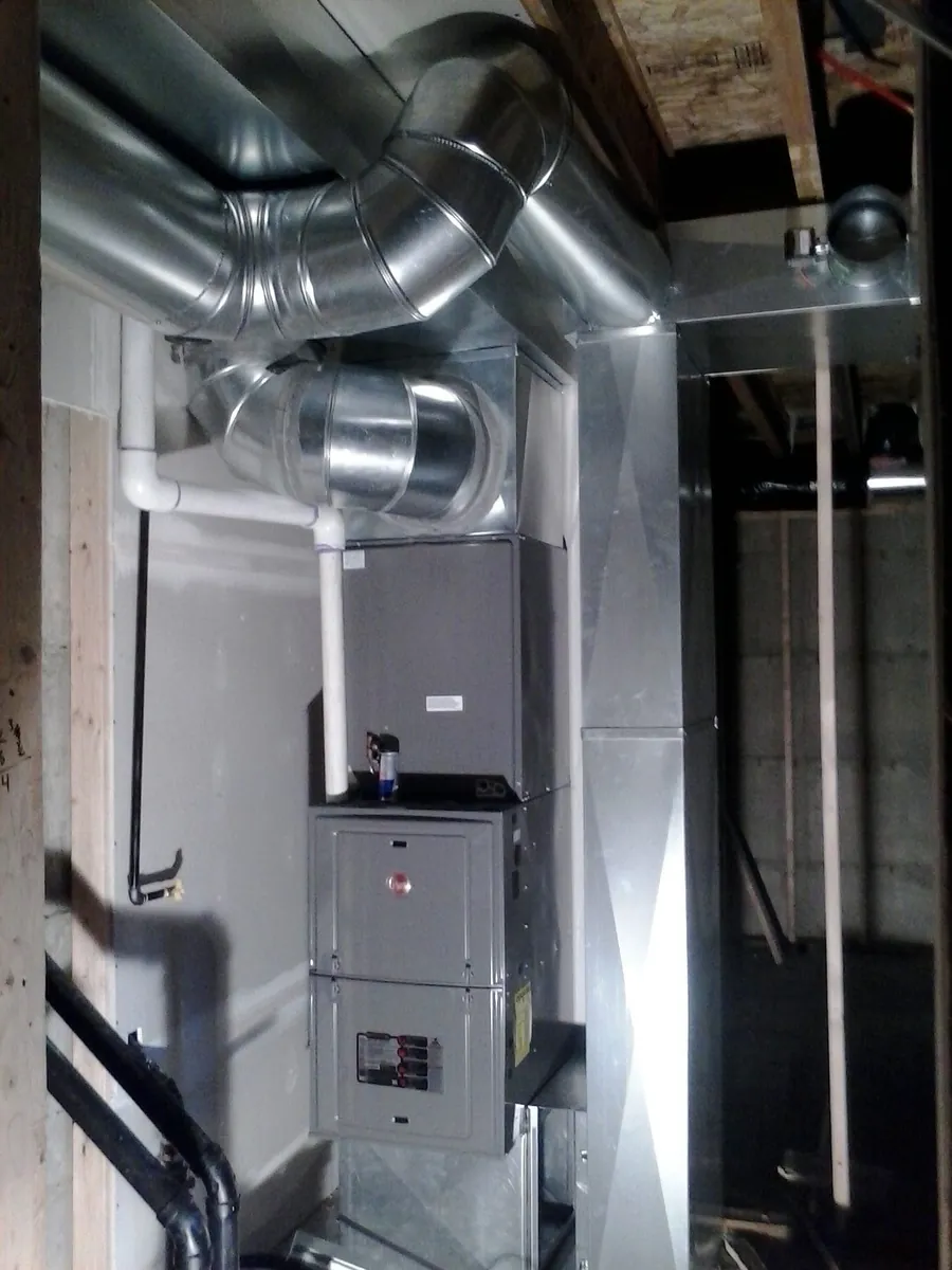 Rheem furnace with metal ductwork in a basement utility space
